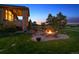 Tranquil backyard with an inviting fire pit and beautiful, mature trees at 4651 Sonado Pl, Parker, CO 80134