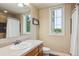 Well-lit bathroom featuring a vanity with a sink, a toilet, and a mirror at 4651 Sonado Pl, Parker, CO 80134