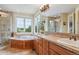 This primary bath boasts double sinks, a soaking tub, and a separate glass shower at 4651 Sonado Pl, Parker, CO 80134