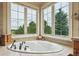 Bright bathroom featuring a garden tub with picturesque views from multiple windows at 4651 Sonado Pl, Parker, CO 80134