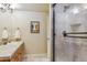 Bright bathroom with a vanity, sink, and a glass-enclosed shower, showcasing modern fixtures at 4651 Sonado Pl, Parker, CO 80134