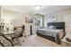 Comfortable bedroom with a plush bed, soft carpeting, and natural light from a window at 4651 Sonado Pl, Parker, CO 80134