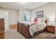 Comfortable bedroom with a cozy bed, soft carpet, and a window providing natural light at 4651 Sonado Pl, Parker, CO 80134