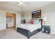 Cozy bedroom featuring a ceiling fan, ensuite bathroom, and plush carpeting at 4651 Sonado Pl, Parker, CO 80134