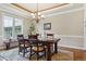 Formal dining room features an elegant chandelier, large window, and hardwood floors with zebra rug at 4651 Sonado Pl, Parker, CO 80134