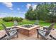 Inviting backyard fire pit with comfortable seating and views of the manicured lawn at 4651 Sonado Pl, Parker, CO 80134