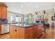 Open kitchen design with an island cooktop and views to the living area at 4651 Sonado Pl, Parker, CO 80134