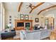 Cozy living room with a stone fireplace, wooden mantel, and comfortable seating at 4651 Sonado Pl, Parker, CO 80134