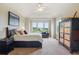 Bright and airy main bedroom with vaulted ceiling, a sitting area, and views of the lush landscape at 4651 Sonado Pl, Parker, CO 80134