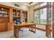 Inviting home office with custom built-ins, natural light, and a comfortable workspace at 4651 Sonado Pl, Parker, CO 80134