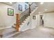 Carpeted staircase with wooden banister and iron spindles, leading to the upper level at 4651 Sonado Pl, Parker, CO 80134