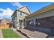 Two-story home with a wooden deck and well-kept lawn, offering a charming backyard space at 17692 Olive St, Broomfield, CO 80023