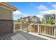 Wooden deck overlooking a street lined with modern townhomes on a bright day at 17692 Olive St, Broomfield, CO 80023