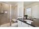 Bathroom featuring a glass shower, vanity, and tasteful decor at 17692 Olive St, Broomfield, CO 80023
