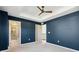 Bedroom featuring a trey ceiling, fan, and large windows offering views at 17692 Olive St, Broomfield, CO 80023
