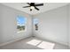 Bedroom with two large windows offering views of the neighborhood on a sunny day at 17692 Olive St, Broomfield, CO 80023