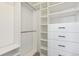 Walk-in closet with custom shelving, drawers, and ample hanging space at 17692 Olive St, Broomfield, CO 80023