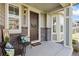 Inviting front porch with seating, decorative wreath, and stylish brick accents at 17692 Olive St, Broomfield, CO 80023