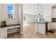 Kitchen view with adjacent living space and modern lighting fixtures at 17692 Olive St, Broomfield, CO 80023
