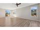 Bright and airy living room featuring wood floors, fan, and plenty of natural light at 17692 Olive St, Broomfield, CO 80023