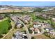 Aerial view of upscale community with golf course and mountain views at 8002 Galileo Way, Littleton, CO 80125