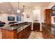 Long granite countertop wet bar with wine rack and cabinetry at 8002 Galileo Way, Littleton, CO 80125