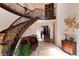 Elegant entryway with curved staircase, ornate railing, and decorative tile floor at 8002 Galileo Way, Littleton, CO 80125