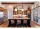 Gourmet kitchen boasting granite counters, custom cabinetry, and a large island at 8002 Galileo Way, Littleton, CO 80125