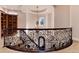 Elegant upper landing with ornate railing and chandelier at 8002 Galileo Way, Littleton, CO 80125