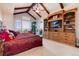 Spacious main bedroom with a large window, built-in cabinetry, and mountain views at 8002 Galileo Way, Littleton, CO 80125