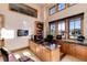 Home office with built-in desk, granite countertop, and abundant natural light at 8002 Galileo Way, Littleton, CO 80125