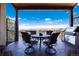 Covered patio with seating area, built-in grill, and stunning mountain views at 8002 Galileo Way, Littleton, CO 80125