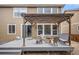 Relax on the outdoor deck with pergola, equipped with stylish seating around a cozy stone fire pit at 14058 Elizabeth St, Thornton, CO 80602
