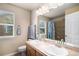 Bathroom with double sinks, a large mirror, and a tub, providing functionality and a bright space at 14058 Elizabeth St, Thornton, CO 80602