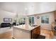 Kitchen with an island overlooking the living room and backyard at 14058 Elizabeth St, Thornton, CO 80602