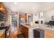 Open concept kitchen with an island overlooking the living room at 14058 Elizabeth St, Thornton, CO 80602