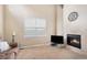 Inviting living room featuring a fireplace, neutral carpeting, and a large window for ample natural light at 14058 Elizabeth St, Thornton, CO 80602