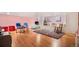 Bright playroom features hardwood floors, colorful walls, and a comfortable space for activities at 14058 Elizabeth St, Thornton, CO 80602