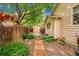 Side yard features a charming wooden pathway surrounded by rocks, plants, and a storage shed at 13112 Summit Grove Pkwy, Thornton, CO 80241