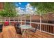 Outdoor deck with a glass table and chairs, surrounded by a decorative lattice fence at 13112 Summit Grove Pkwy, Thornton, CO 80241