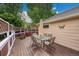 The house features an inviting deck with a glass table, chairs, and cozy wicker seating area at 13112 Summit Grove Pkwy, Thornton, CO 80241