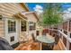Outdoor deck featuring a glass table, seating, and a grill, accessible through a glass paneled door at 13112 Summit Grove Pkwy, Thornton, CO 80241