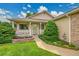 Inviting home exterior featuring a well-manicured lawn, charming front porch, and beautiful landscaping at 13112 Summit Grove Pkwy, Thornton, CO 80241