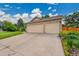 Spacious three-car garage with brick accents and a wide driveway, offering ample parking at 13112 Summit Grove Pkwy, Thornton, CO 80241