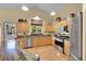 Well-lit kitchen boasts stainless steel appliances and granite countertops with access to the backyard at 13112 Summit Grove Pkwy, Thornton, CO 80241