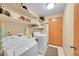 Functional laundry room with washer, dryer, storage shelves and sink providing convenience at 13112 Summit Grove Pkwy, Thornton, CO 80241