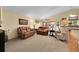 Cozy living room with neutral tones, leather sofas, large windows, and plush carpeting at 13112 Summit Grove Pkwy, Thornton, CO 80241