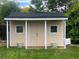 Backyard shed with double doors and two windows, perfect for storage at 13112 Summit Grove Pkwy, Thornton, CO 80241