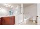 Bathroom featuring a glass shower, tub, modern sink, cabinets, toilet, and mirror at 3985 W 104Th Dr # E, Westminster, CO 80031