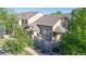 Charming townhome with stone accents, a private balcony, and lush landscaping at 3985 W 104Th Dr # E, Westminster, CO 80031